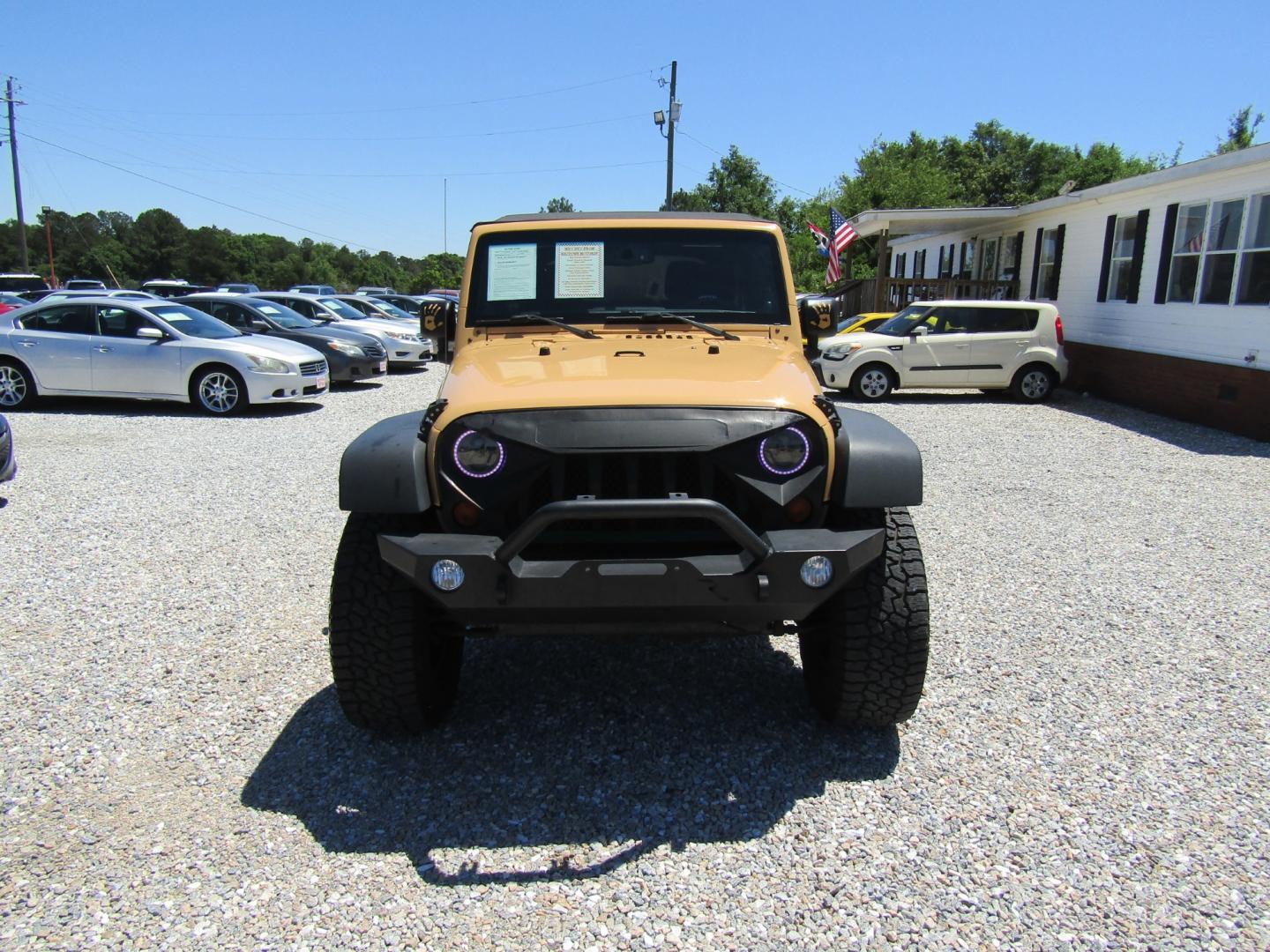 2013 Tan /Black Jeep Wrangler Unlimited Sahara 4WD (1C4HJWEG7DL) with an 3.6L V6 DOHC 24V FFV engine, Automatic transmission, located at 15016 S Hwy 231, Midland City, AL, 36350, (334) 983-3001, 31.306210, -85.495277 - Photo#1